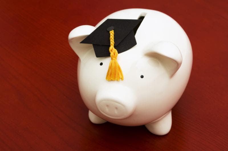 white piggy bank with a small graduation cap morterboard