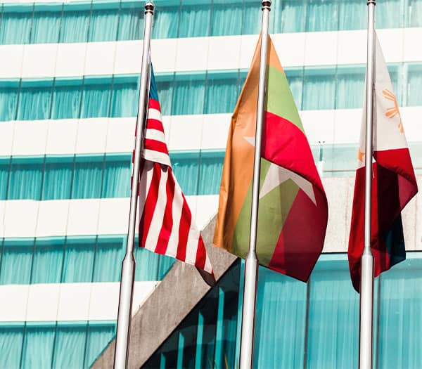 international-consulting international flags outside a glass skyscraper